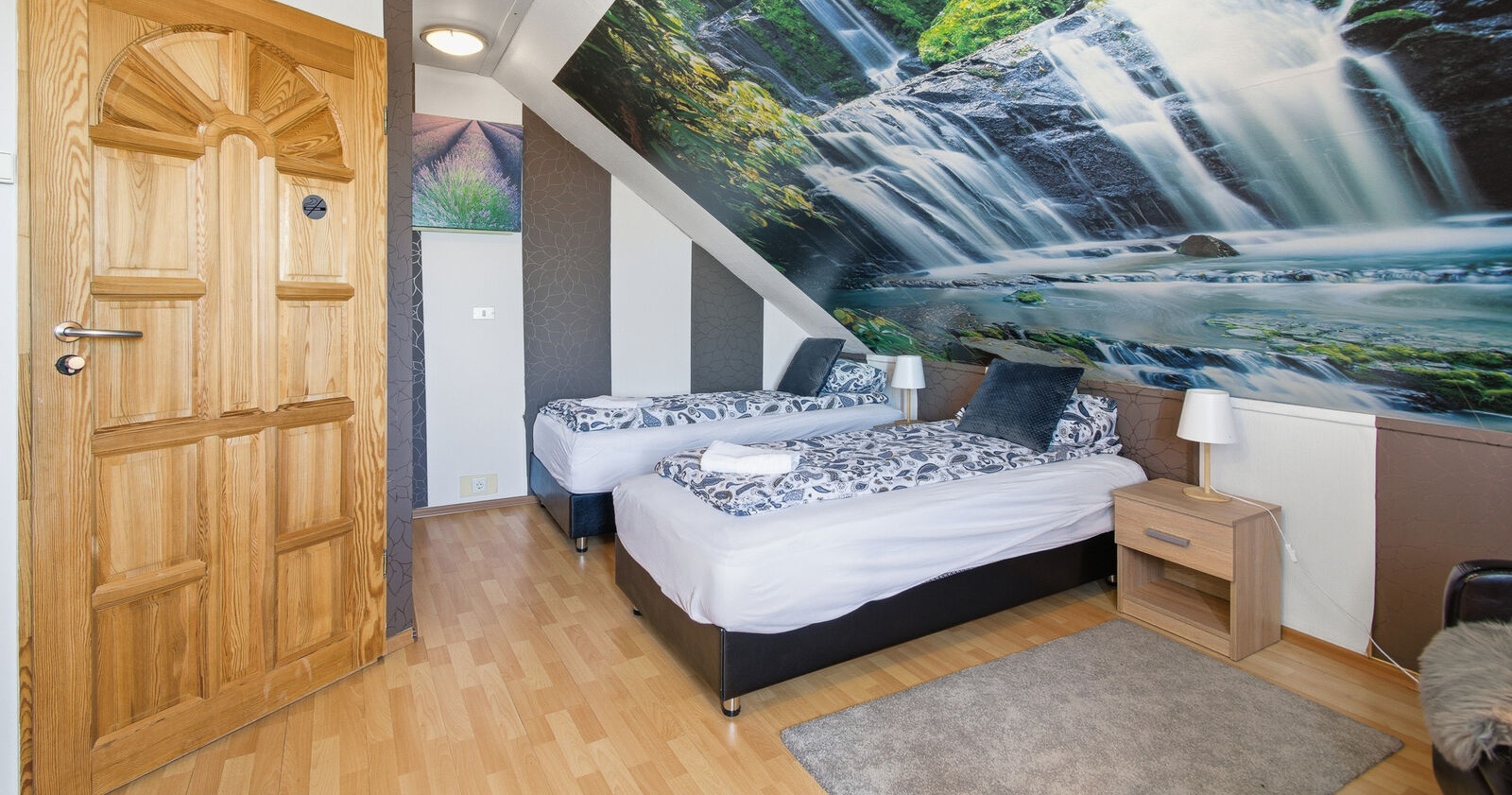 Attic room with waterfall mural